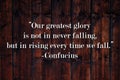 Our greatest glory is not in never falling, but in rising every time we fall.  Inspirational quote on vintage retro background. Royalty Free Stock Photo